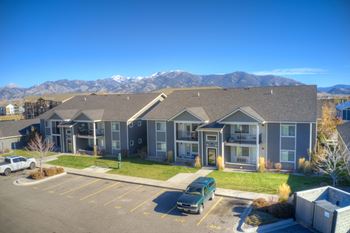 an apartment building with mountains in the background at Madison Park, Montana, 59718